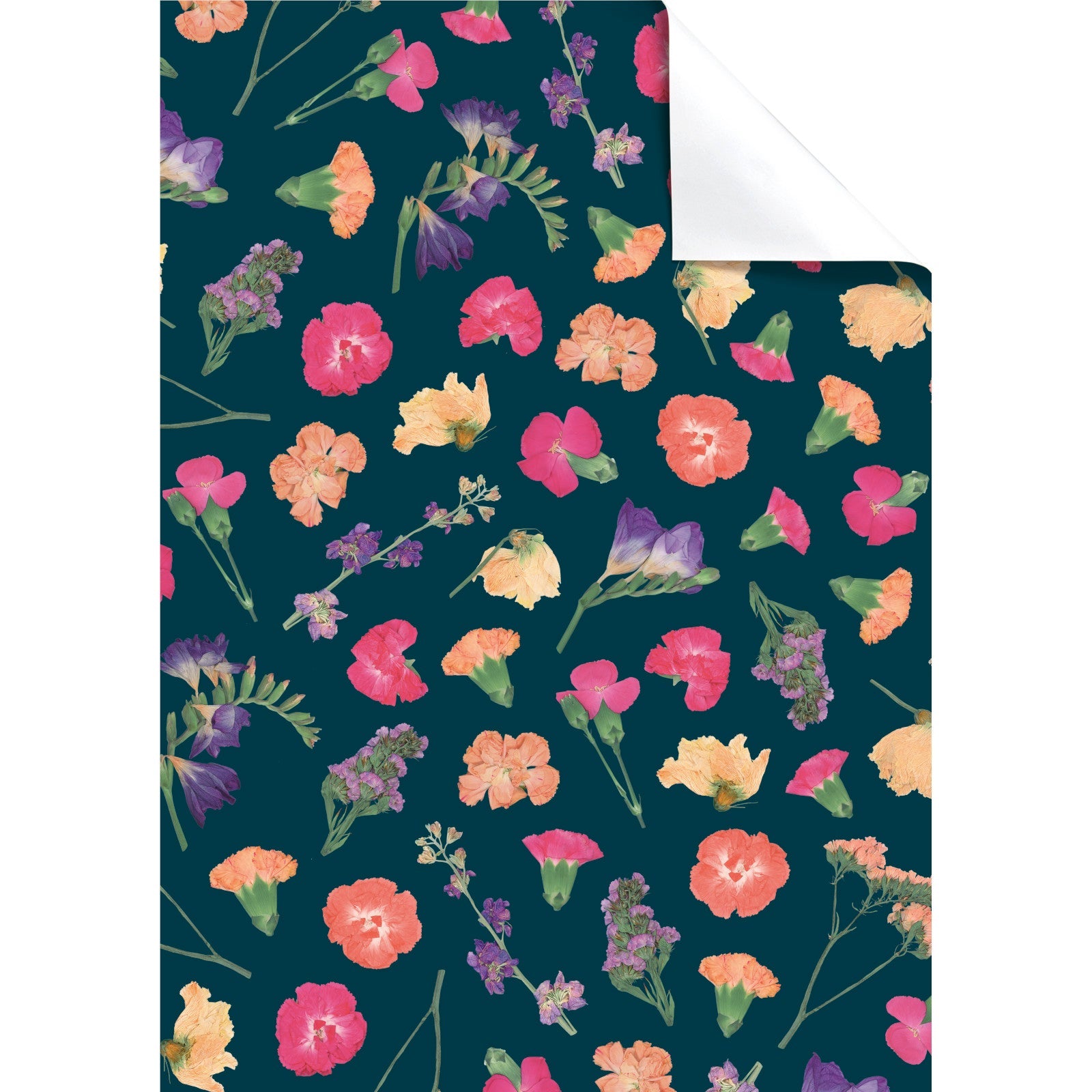 A sheet of wrapping paper with a dark green background and pressed flowers scattered across it in different shades of pink and purple.