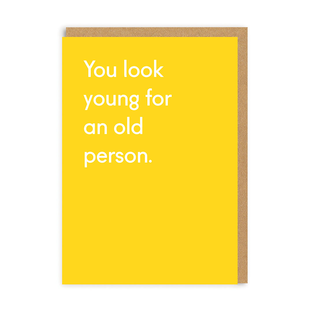 a bright yellow greetings card featuring white writing saying 'you look young for an old person'.