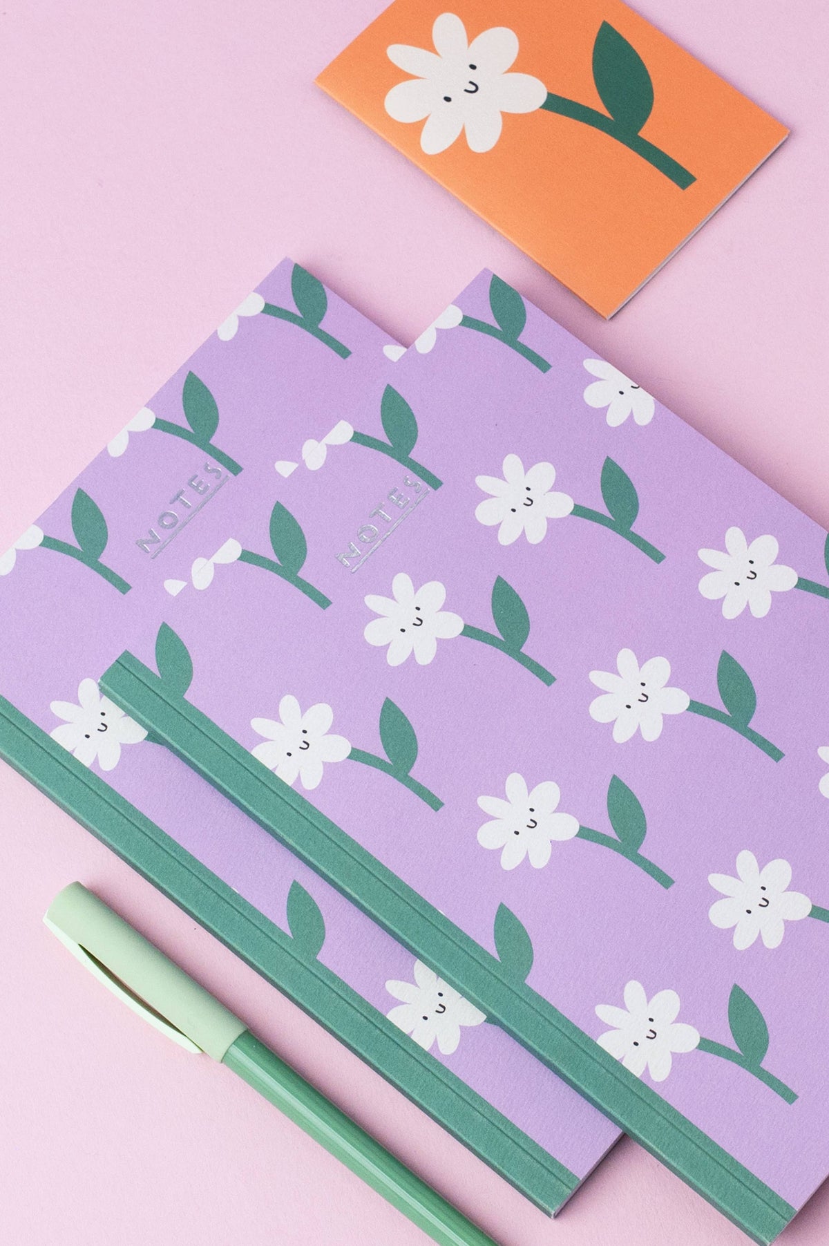 Flower Face Blank Journal Notebooks on a desk by penny black