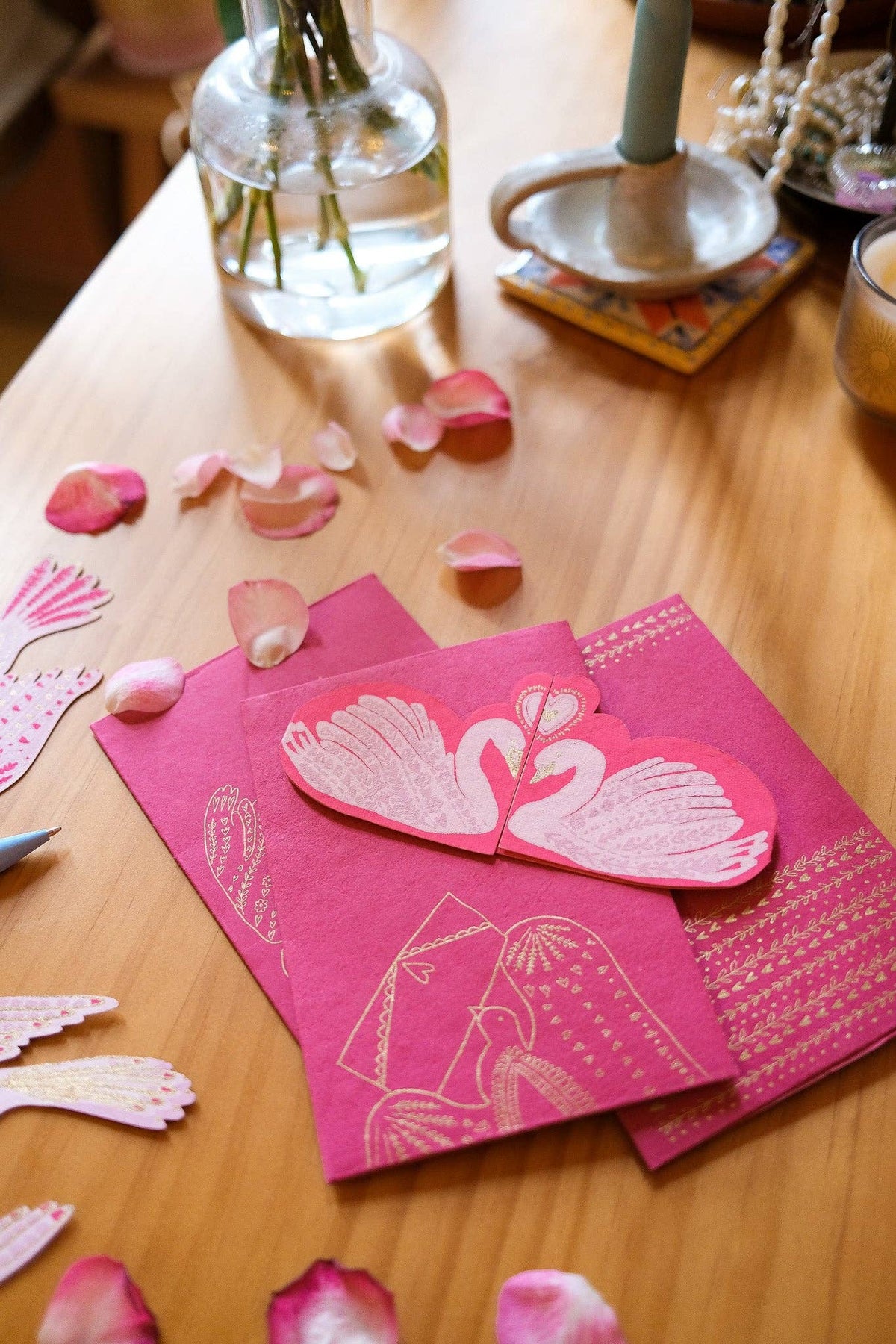 Kissing Swans Hand Printed Valentine Card on a table by penny black