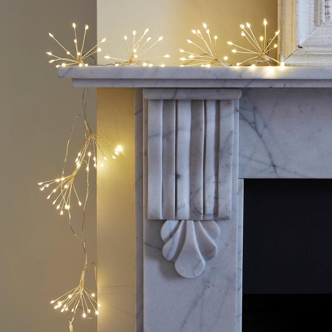 Allium Starburst LED String Lights on a mantlepiece by penny black