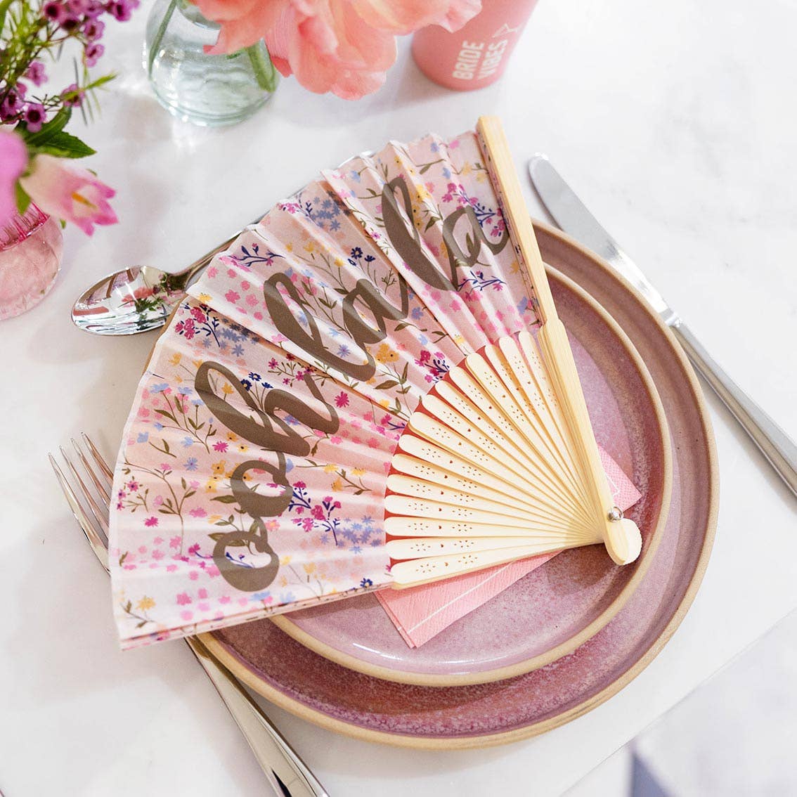 Ooh La La Floral Handheld Fan - folded out at a wedding place setting by penny black